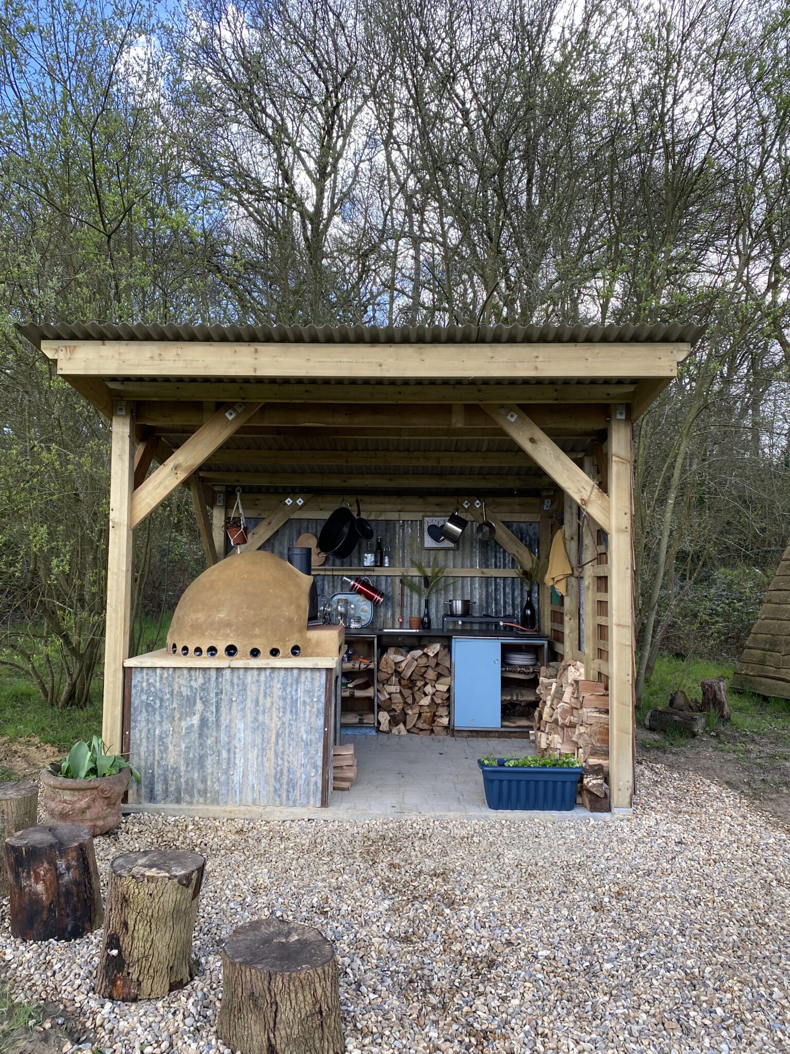Outdoor kitchen with pizza oven at Tiny Homes Holidays